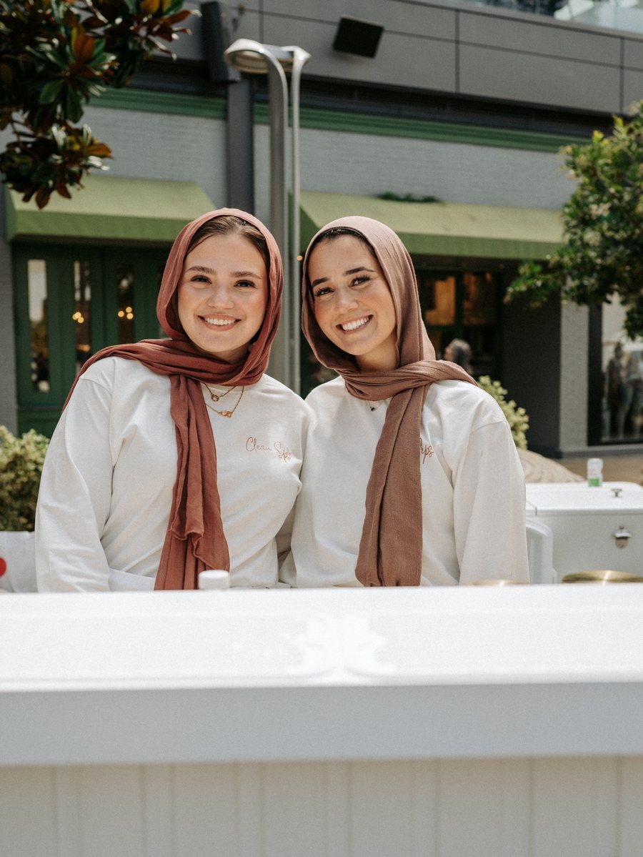 Asmaa and Hiba behind the Clean Sips cart