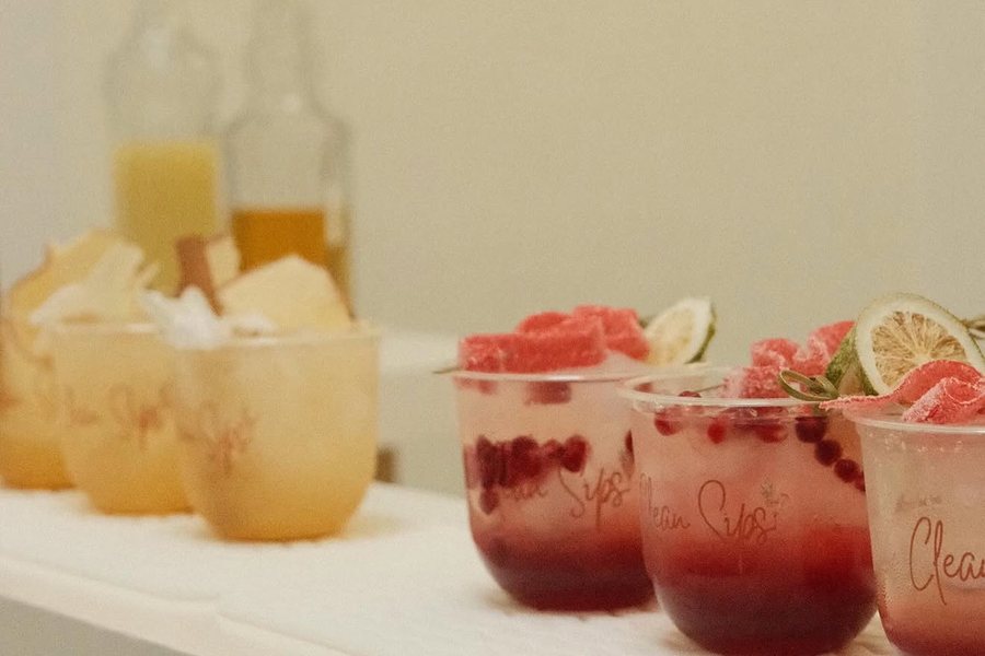 Two rows of Clean Sips mocktails lined up on the cart at a first birthday